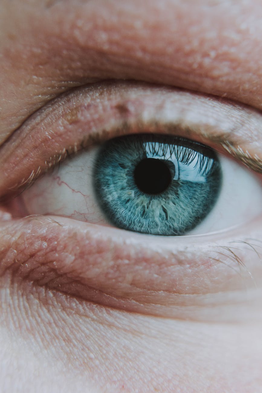 crop unrecognizable person with bright eye and rare eyelashes